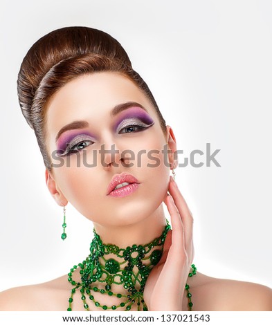Sensual Brunette with Bright Purple Eye Make-up and Jewelry. Glamor