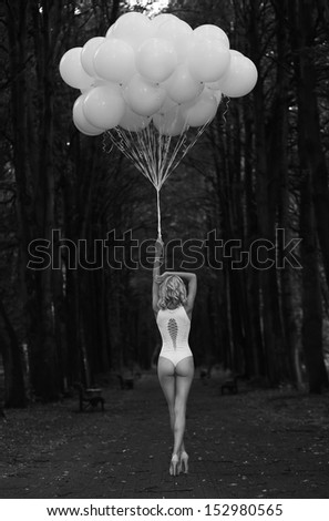 Melancholy. Lonely Woman With Balloons In Dark And Gloomy Forest