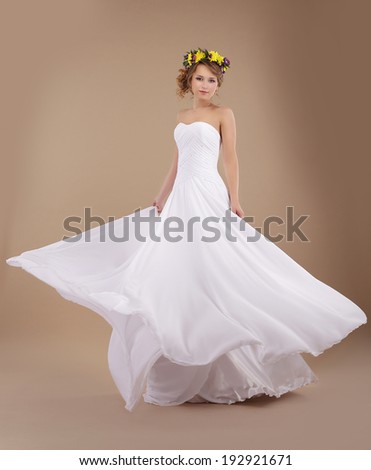 Bride with Vernal Wreath of Flowers in Flying Wedding Dress