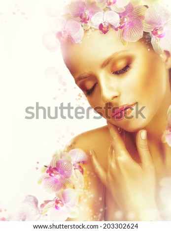 Complexion. Gorgeous Woman with Perfect Bronzed Skin and Orchid Flowers. Fragrance