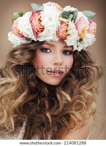 Romantic Woman in Wreath of Flowers with Perfect Skin and Frizzy Hair