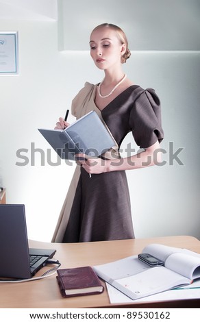 Business style - stylish lovely businesswoman reporting at working space. Series of photos