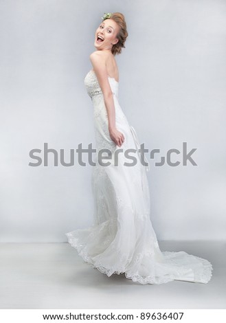 Lifestyle - dancing cheerful bride in long wedding white dress