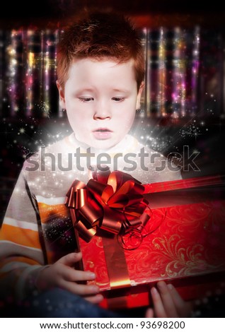 Birthday - lovely excited little red hair kid looking happily into red box - birthday gift