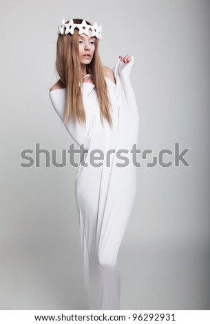 beauty woman in white crown wearing unusual clothes - stock photo