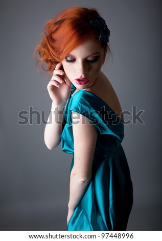Emotions - red hair freckled bright beautiful young woman posing. Studio shot