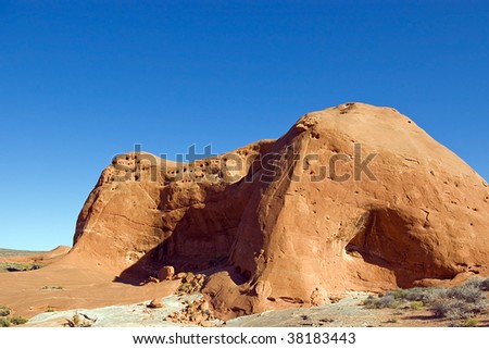 A large red rock formation in the Utah desert called Dance Hall Rock.