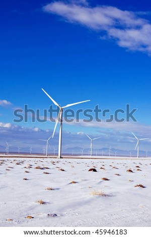 New wind turbines produce energy at a high desert wind farm.
