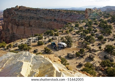 View of truck and camper at a remote desert site.