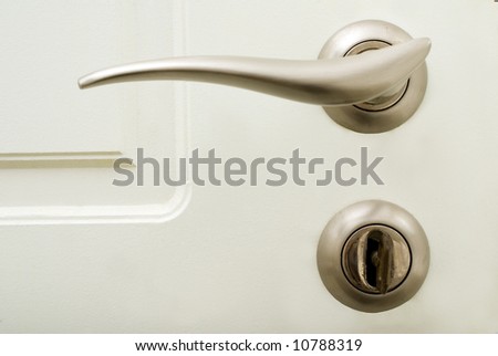 white house door with stainless steel door handle and lock with key