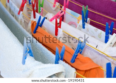 colorful plastic cloth pegs on hanging clothes drying outside