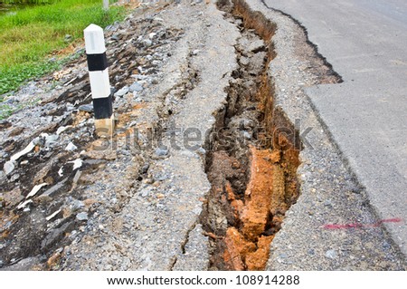 collapsed and cracked asphalt road after flood