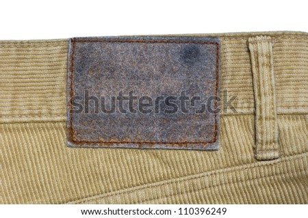 close up of old leather label of Corduroy trousers in jeans style