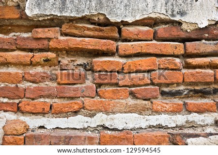 Old weathered wall crack and fragment show the brick inside