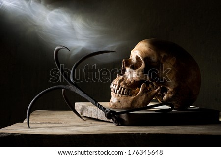Still life photography, Human skull with steel hook and smoke,  in dreadful human soul concept