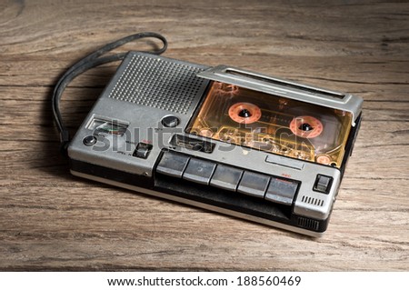 old Cassette Tape player and recorder with audio cassette on old wood background