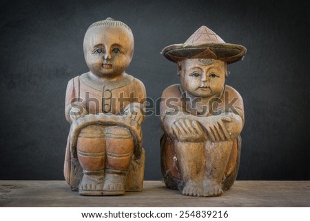old traditional wood carved in trusted couple, made to sell the tourist for souvenir