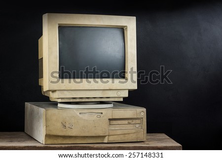 still photography : old and obsolete computer on old wood with art dark background