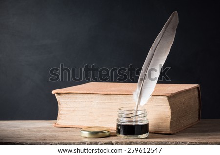 still life photography : inkwell and quill with old books on art dark background