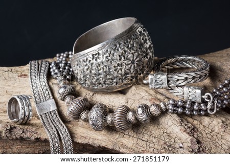 Still life photography : Collection of antique traditional silver jewelry on old wood