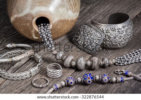 Collection of antique traditional silver jewelry on old wood
