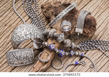 Collection of antique traditional silver jewelry on old wood