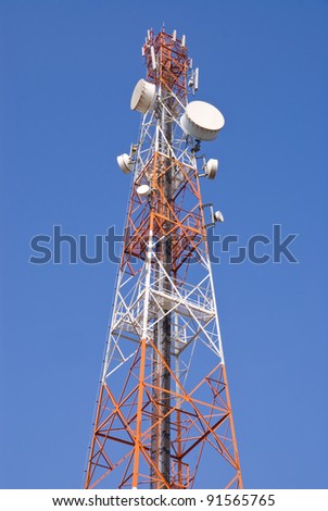 Telecommunication tower with microwave link antennas against blue sky