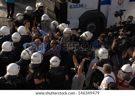 ISTANBUL - JULY 06: Police forces interfere Taksim Solidarity and Republican People's Party (CHP) deputy chairman, Gursel Tekin  during Gezi Park protests on July 06, 2013 in Istanbul, Turkey.