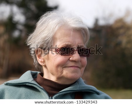 Happy old lady with sunglasses