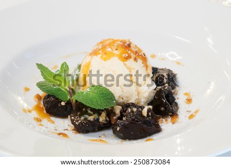 Plums marinated in rum with vanilla ice cream and caramel sauce