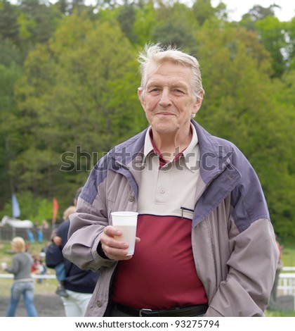 Old active men drinking beer from pot