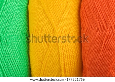background of yarn skeins in yellow, orange and green colors