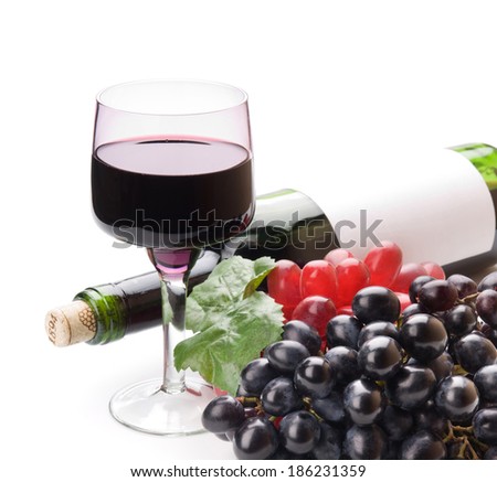 Glass of black wine and grapes on white background