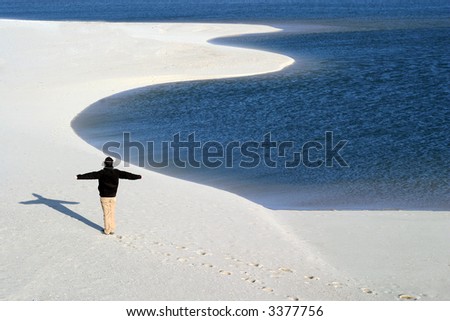 man with arms wide open in the beach