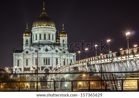 Moscow, Russia - September 19: Christ the Saviour Cathedral in September 19, 2013 brightly lit by floodlights at night and footbridge \