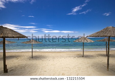 Sun umbrellas at the beautiful Possidi beach on the west side of Kassandra Peninsula, Chalkidiki, Greece