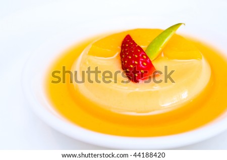 Creme caramel with strawberry and apple slices. White isolated