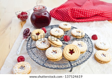 Jam-filled cookies and raspberries