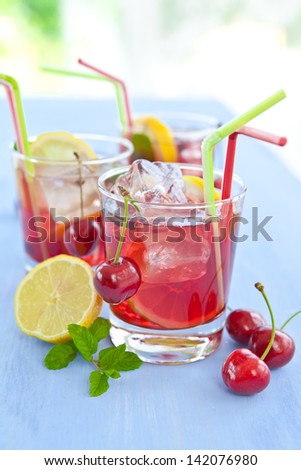 Homemade  lemonade / iced tea with fresh cherries, lemons and mint