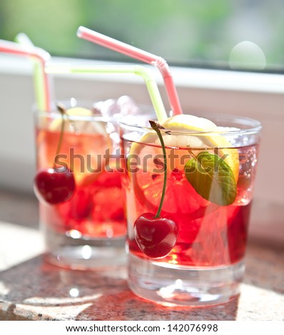 Homemade  lemonade / iced tea with fresh cherries, lemons and mint