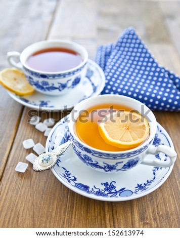 Various teas with fresh lemon in white and blue china cups