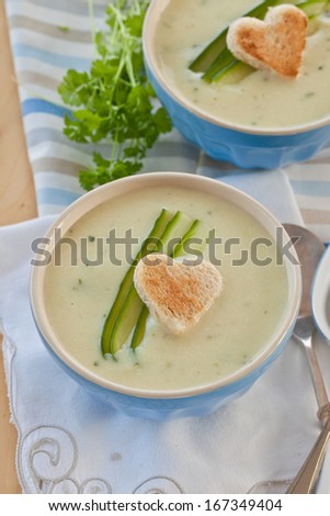 Creamy vegetable soup with fresh cucumber and toasted bread