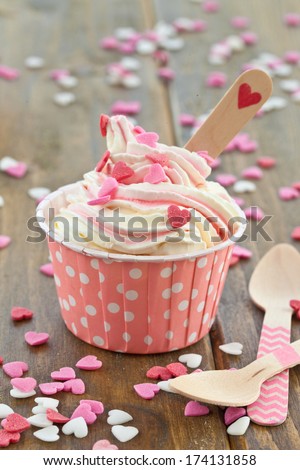 Frozen Yogurt with colorful sugar hearts in pink paper cups