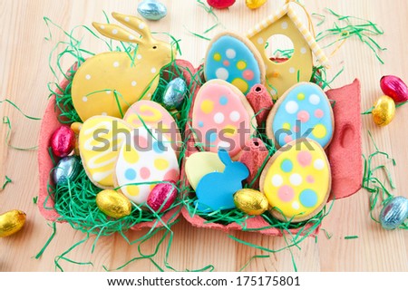 Colorful egg-shaped cookies and chocolate eggs for easter