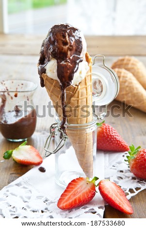 Various ice creams in waffle cone with chocolate sauce