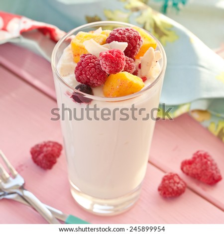 Fresh yogurt with raspberries, mango and coconut