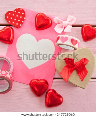 Chocolate hearts and colorful gift wrapping material