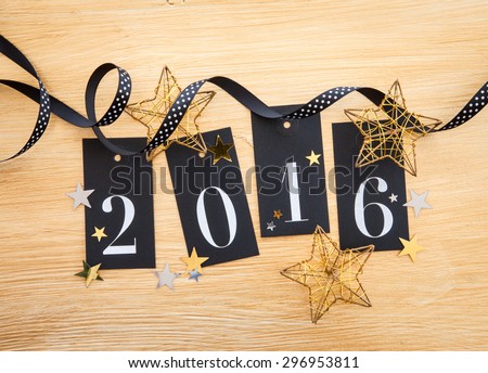 2016 written on gift tags with glittery christmas decoration