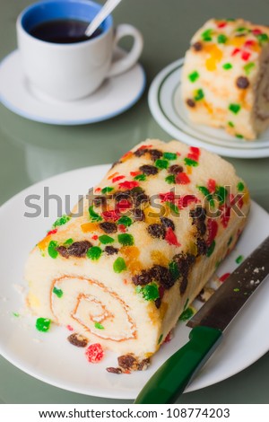 Loaf of roll sponge cake full with fruit garnish