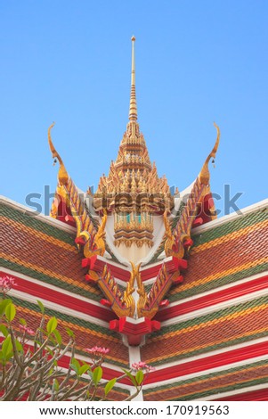 Thai buddhist temple roof gable with tiered and carved apex